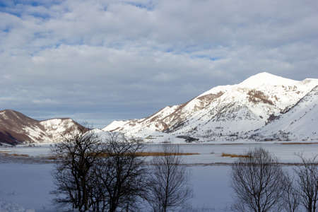 mountain landscape with snow and iced lakeの写真素材