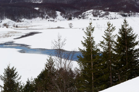 mountain landscape with snow and iced lakeの写真素材