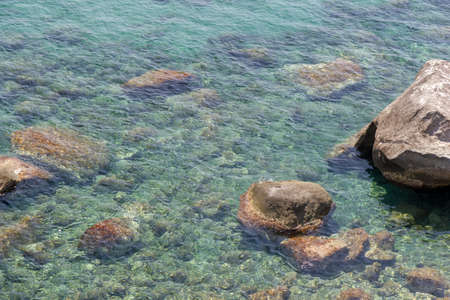 transparent sea with rocks in ischia forioの写真素材