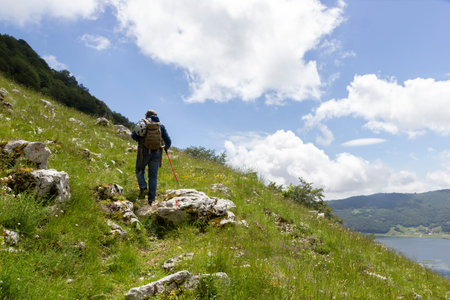 hiker in the mountains with lake in matese park
