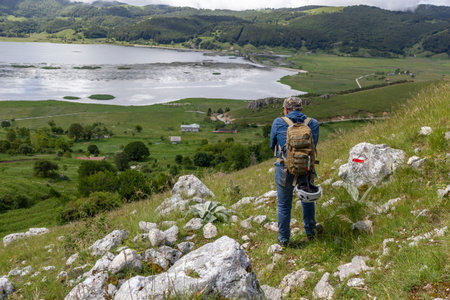 hiker in the mountains with lake in matese park