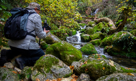 hiker take photo on wonderful waterfalls of the cypress forest of fontegrecaの写真素材