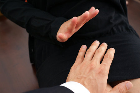 Businessman sexually harassing female colleague by trying to touch her
