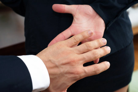 Workplace harassment inappropriate behavior towards a colleague, crossing professional boundariesの写真素材