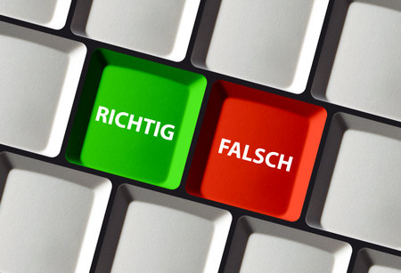 A closeup of keyboard keys marked Right and Wrong in German, representing decisionmaking in a...
