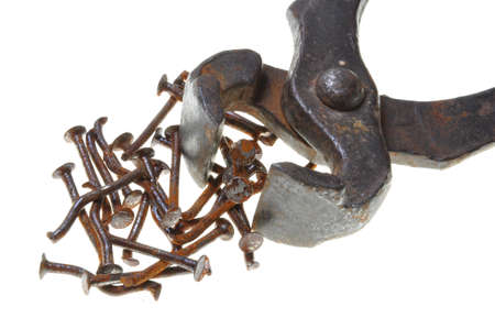 Old rusty pincers and nails on a white backgroundの写真素材