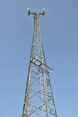 Telecommunication cell phone tower against blue sky 