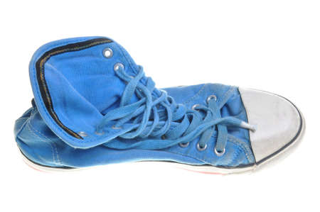 Old blue sneaker isolated on white background の写真素材