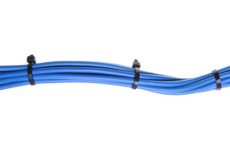 Blue electrical cables with cable ties isolated on white 
