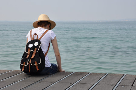 Loneliness teenagers at the sea shore の写真素材