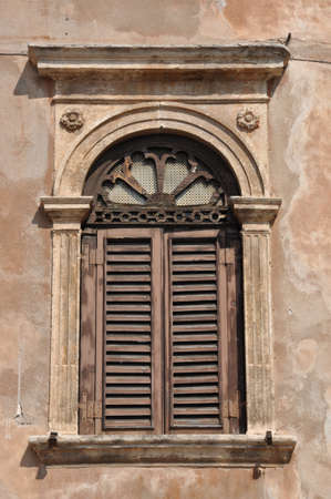 Old window on a building in the Italian townの写真素材