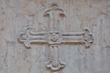 Carved cross on wall stone の写真素材