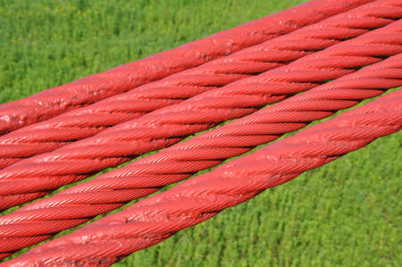 Steel lines of the bridge against the green meadow の写真素材