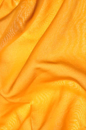 Smooth draped satin as yellow background の写真素材