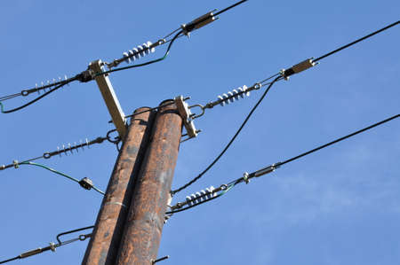 Wooden electric pole with power line の写真素材
