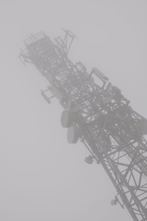 Telecommunication tower with antennas in the mistの写真素材