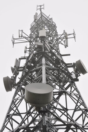 Telecommunication tower with antennas in the mist
