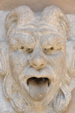 Stone head gargoyle decorative element 