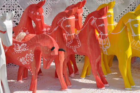 Handmade wooden toys horses on a street market の写真素材