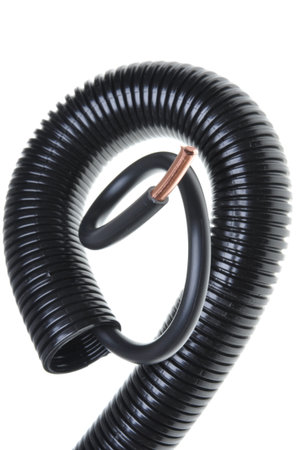 Corrugated pipe with black cable isolated on white background 	Corrugated pipe with black cable...