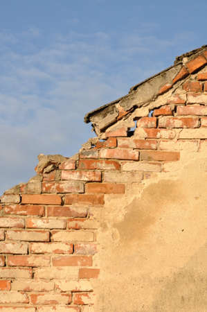 Old brick wall against the blue skyの写真素材