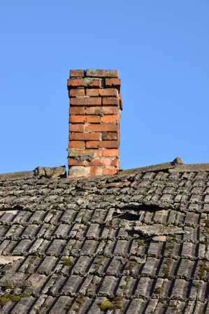 Old roof with brick chimneyの写真素材