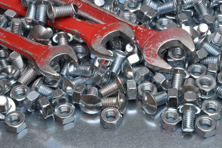 Wrenches with nuts and bolts on metal surface