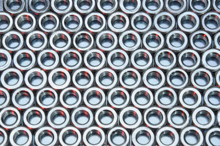 Shiny nuts on metal surface abstract industry backgroundの写真素材