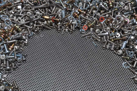 Screws nuts and bolts on steel surfaceの写真素材