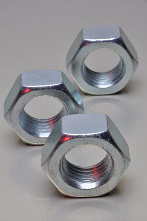 Group of steel nuts with light reflection