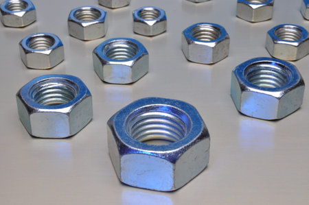 Steel nuts on metal surfaceの写真素材