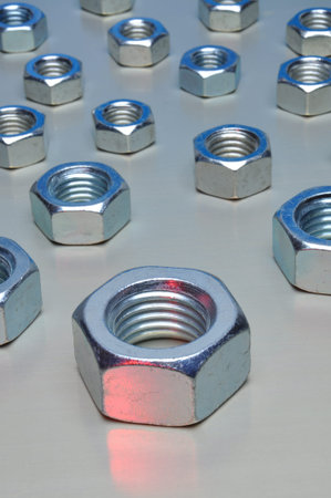 Steel nuts on metal surface