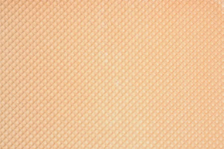Golden waffle background with regular patternの写真素材