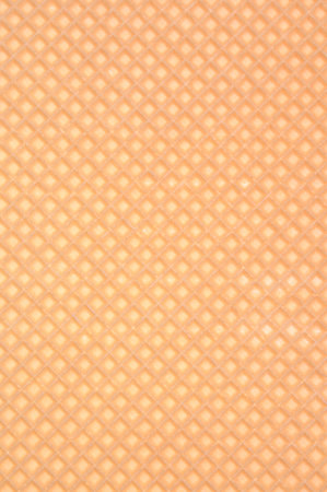 Golden waffle background with regular patternの写真素材