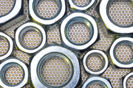 Shiny nuts on metal surface abstract background