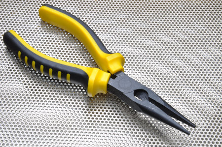 Pliers on metal surface