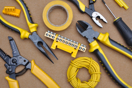 Tools for electrical installation on brown felt