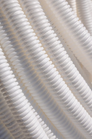 White plastic corrugated pipe as background