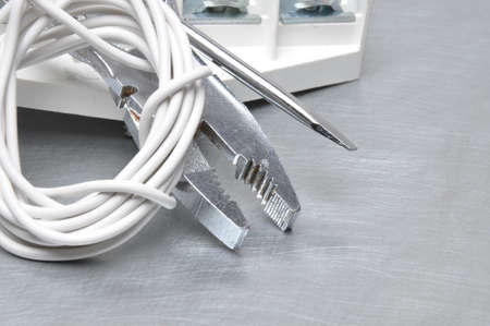 Electrical tools and cables on metal surface with place for textの写真素材