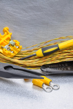 Electrical tools and cables on metal surface with place for text