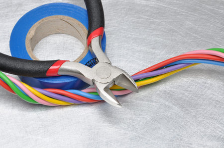 Electrical tools and cables on metal surface with place for textの写真素材