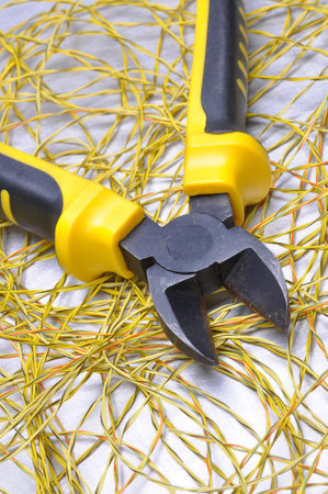 Electrical tools and cables on gray metal surface