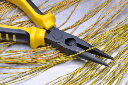 Electrical tools and cables on gray metal surface