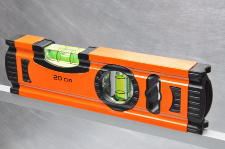 Construction tool spirit level on line of metal profiles