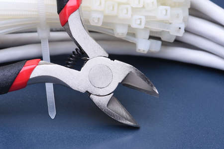 Pliers with cables and a bunch of cable tiesの写真素材