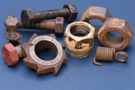 Old mechanical parts on blue metal backgroundの写真素材