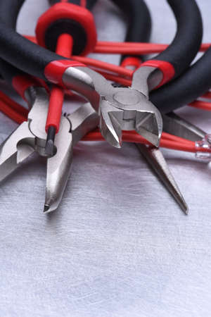 Tools for electrician and cables on gray metal surfaceの写真素材