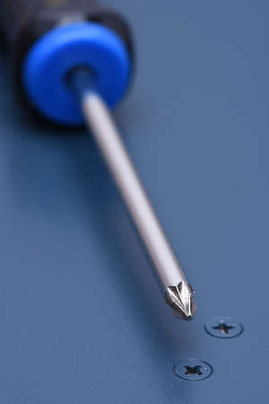 Screwdriver and screws on metal surface with selective focusの写真素材