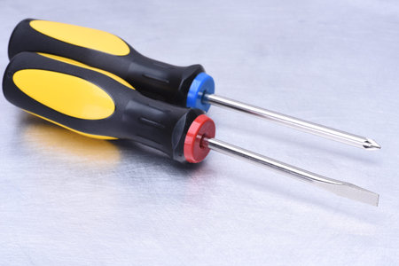 Two screwdrivers on metal background