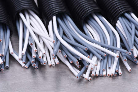 Electric cables in corrugated plastic pipes on metal surfaceの写真素材